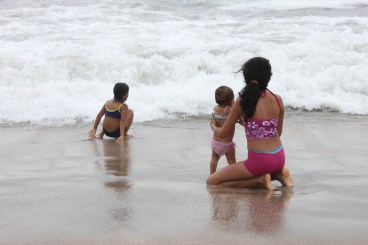 sisters playing in the waves